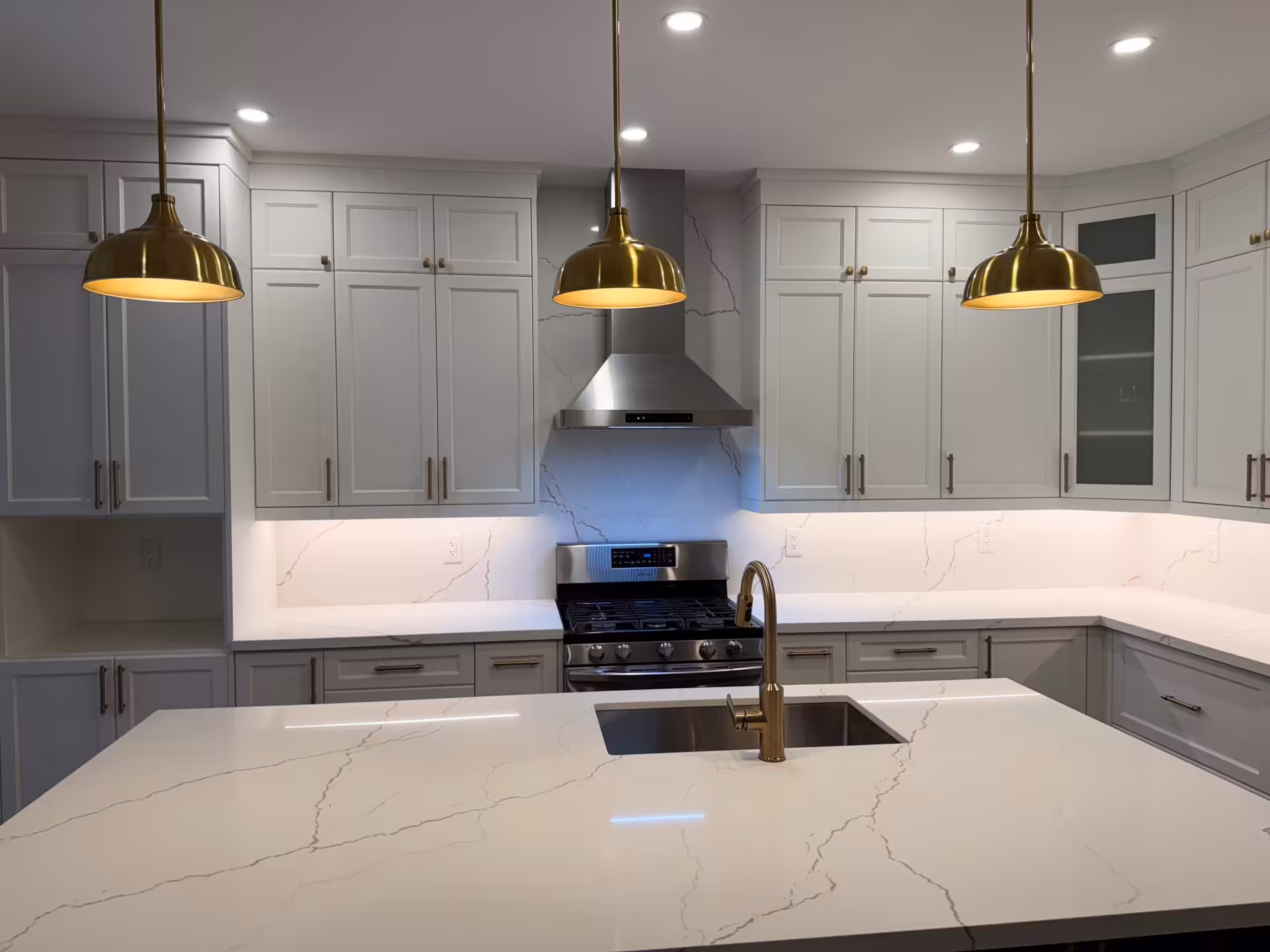 Kitchen with a waterfall-edge marble island