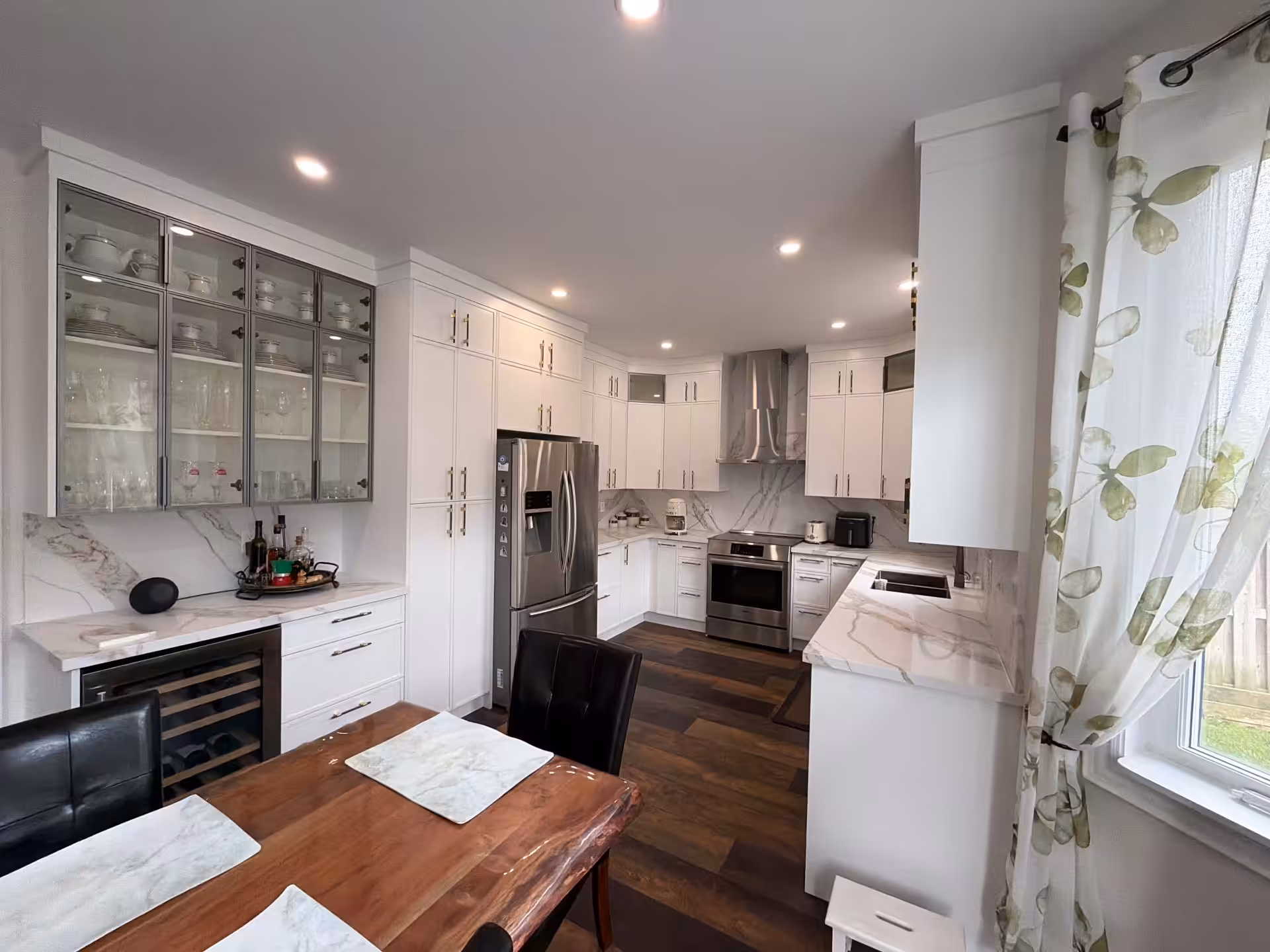 Kitchen with glass-front upper cabinets and butcher-block counter