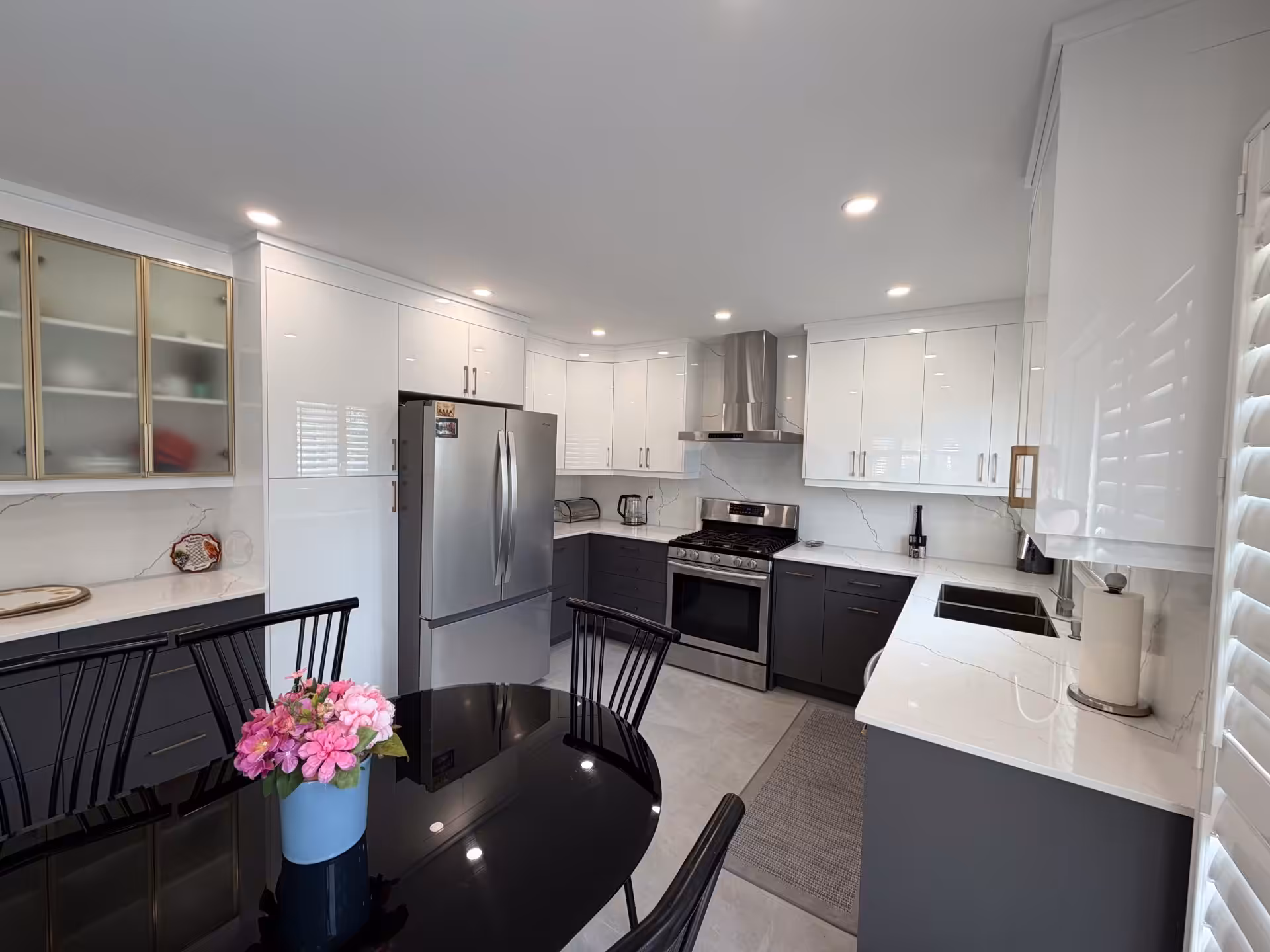 White kitchen with island and sliding barn door to the pantry