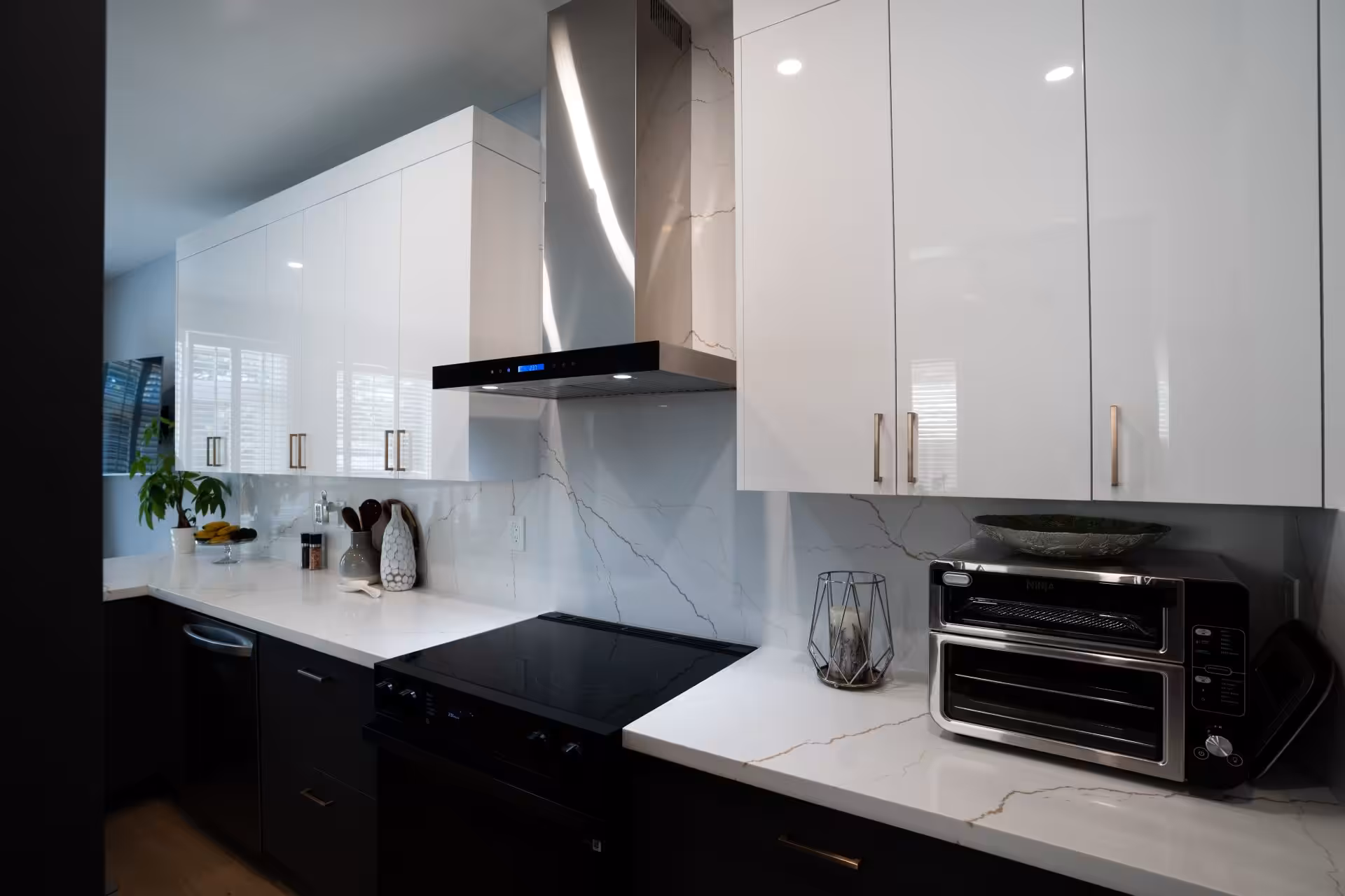 Kitchen with a statement range hood and quartz backsplash