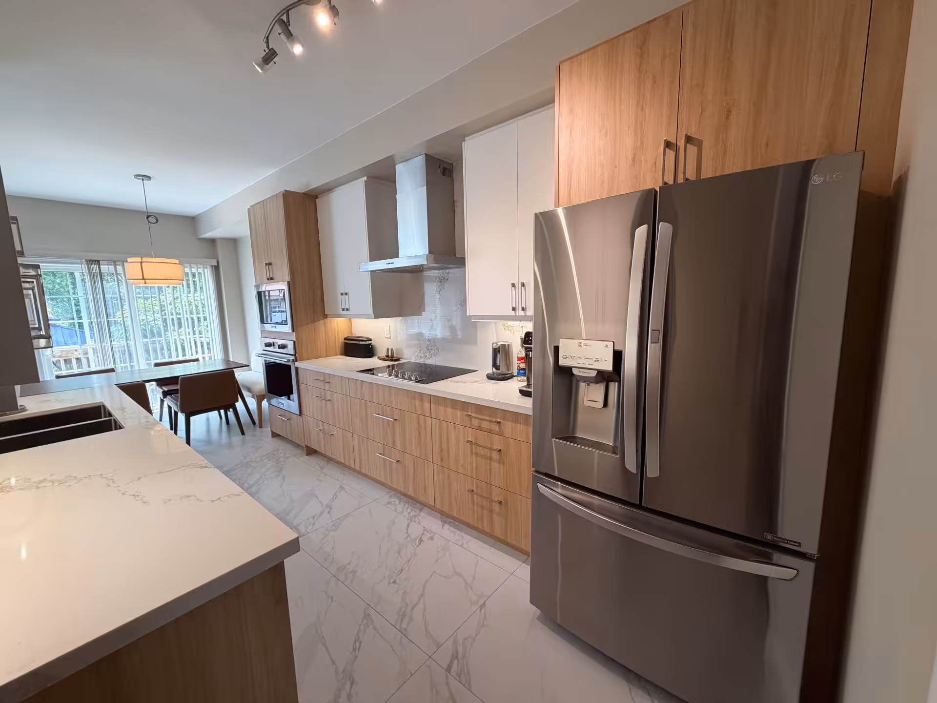 Wood-grain kitchen with a full-height pantry wall