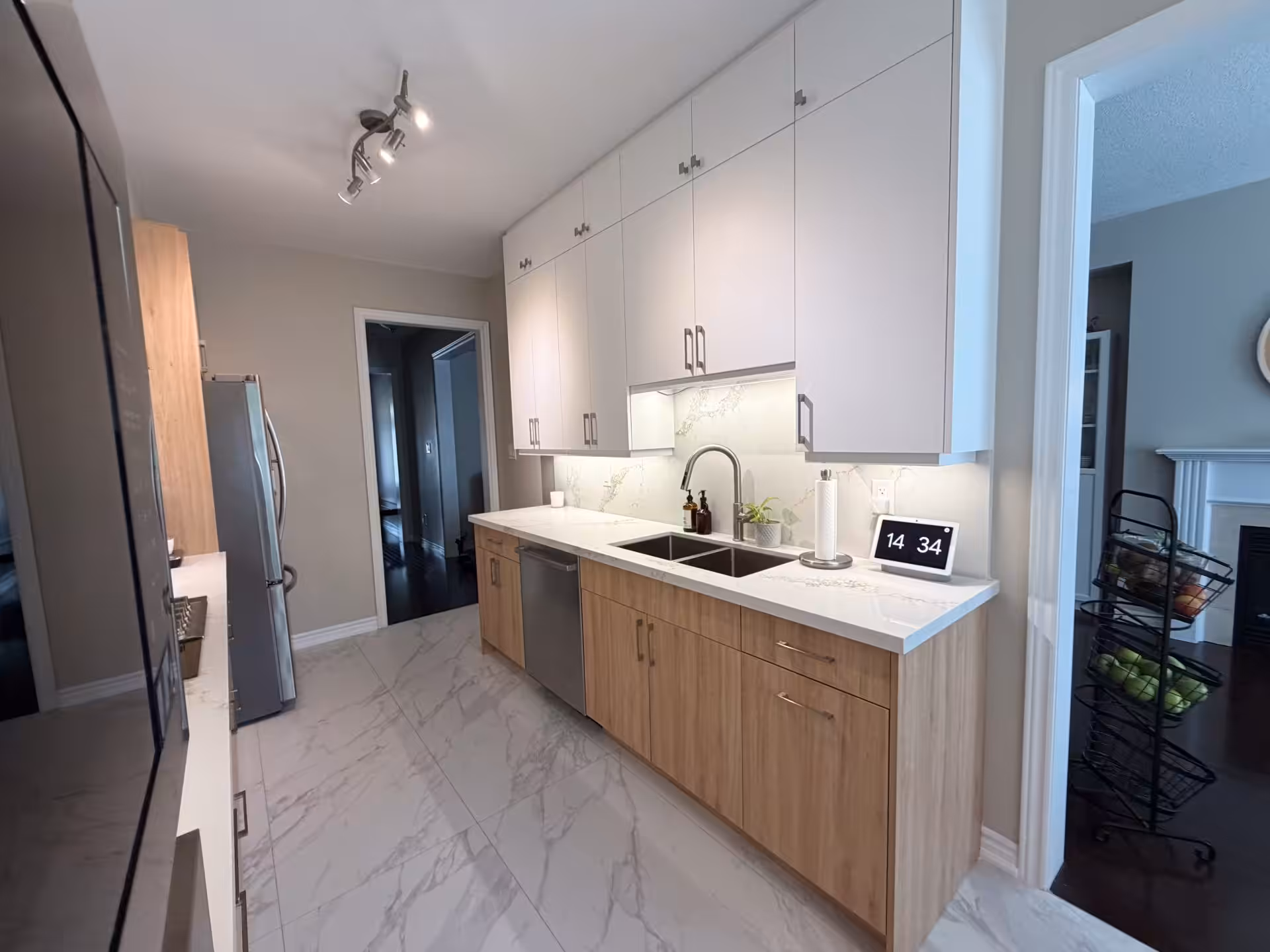 Galley kitchen with dark lower cabinets and white uppers