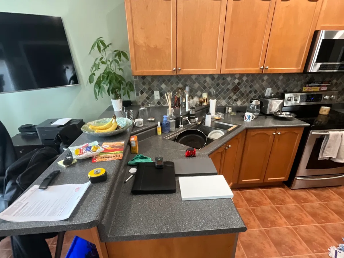 Before: honey-oak cabinets, a speckled laminate peninsula and terracotta tile