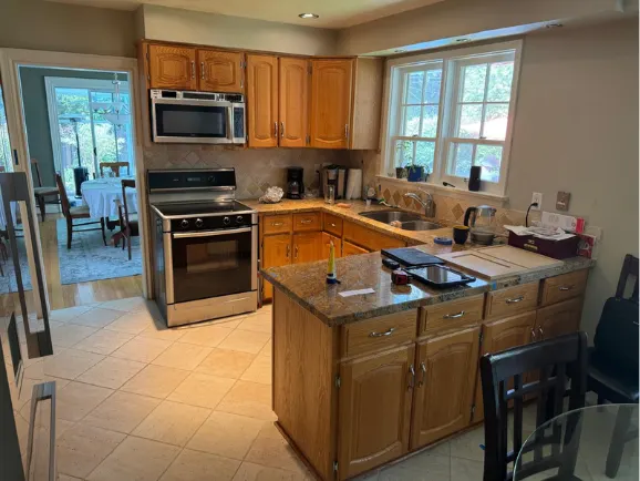Golden oak kitchen with dated counters and appliances