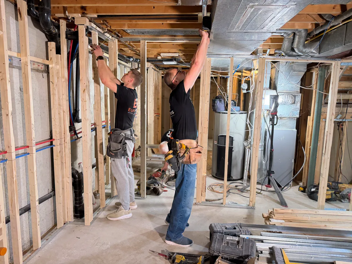 Two of our carpenters framing a basement