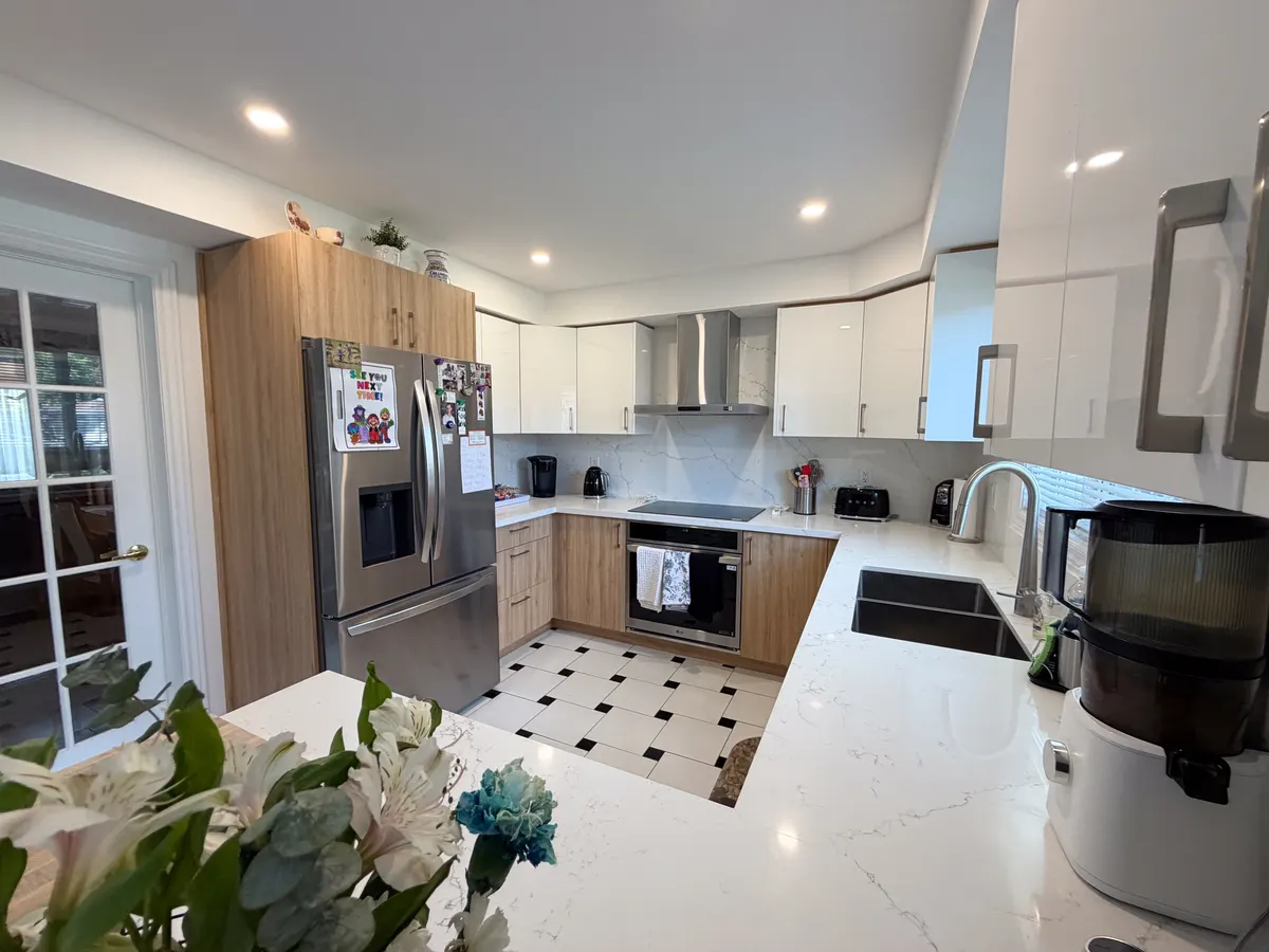 Wood-grain kitchen with white uppers and a chequerboard tile floor