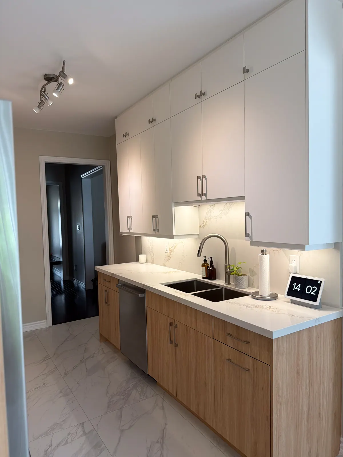 Wood and white kitchen with a marble waterfall island